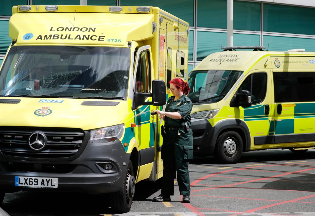 An ambulance worker is seen beside a London Ambulance outside University College Hospital in London on July 17, 2020. - Boris Johnson said on July 17 he hoped Britain would "return to normality" by November despite being badly affected by the coronavirus and predictions of a second wave of cases during winter months. Johnson announced that to prepare for a possible winter spike in cases the state-run National Health Service (NHS) would receive an extra £3 billion ($3.8 billion, 3.3 million euros). (Photo by Tolga AKMEN / AFP) (Photo by TOLGA AKMEN/AFP via Getty Images)