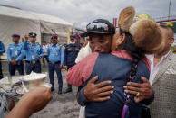 Veteran Sherpa guide Kami Rita, hugs his wife as he arrives at the airport in Kathmandu, Nepal, Thursday, May 25, 2023. The 53-year-old guide scaled Mount Everest for the 28th time on Tuesday beating his own record within a week as two guides compete with each other for the title of most climbs of the world's highest peak. (AP Photo/Niranjan Shrestha)