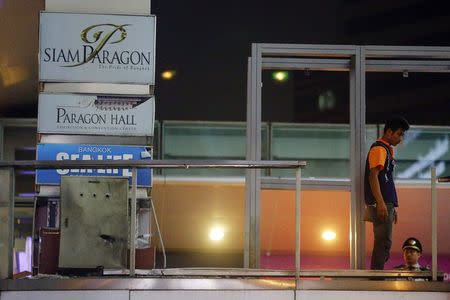 A man works at the site of a blast on an elevated walkway linking an overhead rail line to the Siam Paragon mall in central Bangkok early February 2, 2015. REUTERS/Damir Sagolj