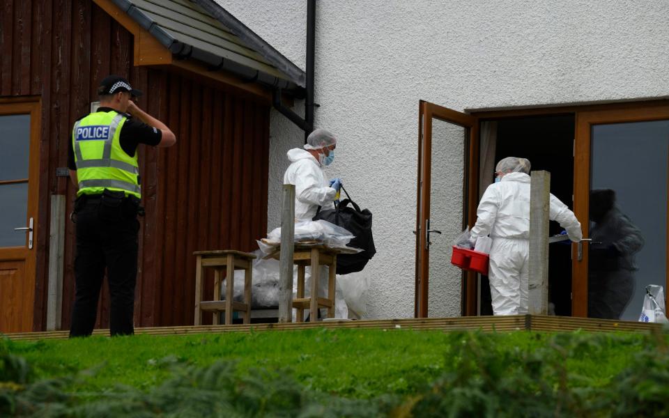 Forensics officers investigate a property in connection with the shooting - John Linton/PA