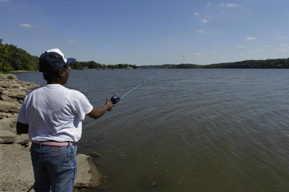 In this Sept. 12, 2012 photo, a woman fishes on Lake Decatur, which was built on the Sangamon River in the 1920s to serve the town and another local agricultural processor, in Decatur, Ill. As the drought of 2012 grew drier by the hot summer week, many Midwestern towns turned to water-use restrictions to preserve what they had. (AP Photo/Seth Perlman)