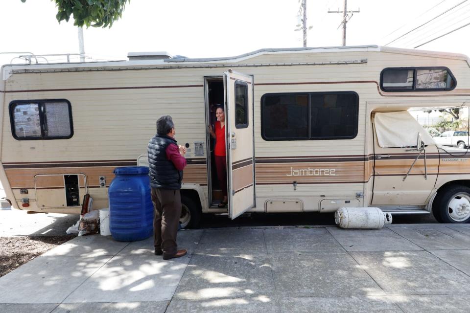 Efrain Sandoval visits a homeless woman