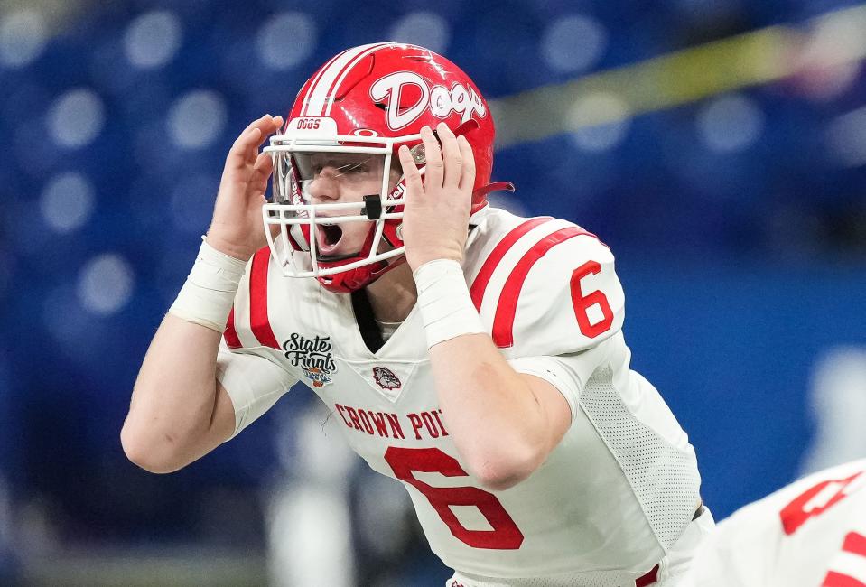 Crown Point Bulldogs quarterback Noah Ehrlich (6) yells to teammates on the line of scrimmage Saturday, Nov. 25, 2023, during the IHSAA Class 6A football state championship game at Lucas Oil Stadium in Indianapolis. The Ben Davis Giants lead at the half against the Crown Point Bulldogs, 10-3.