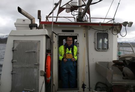 Sea Sami fisherman Tommy Pettersen, 47, stands onboard his boat while he fishes for king crabs in Repparfjord, Norway, June 13, 2018. REUTERS/Stoyan Nenov/Files