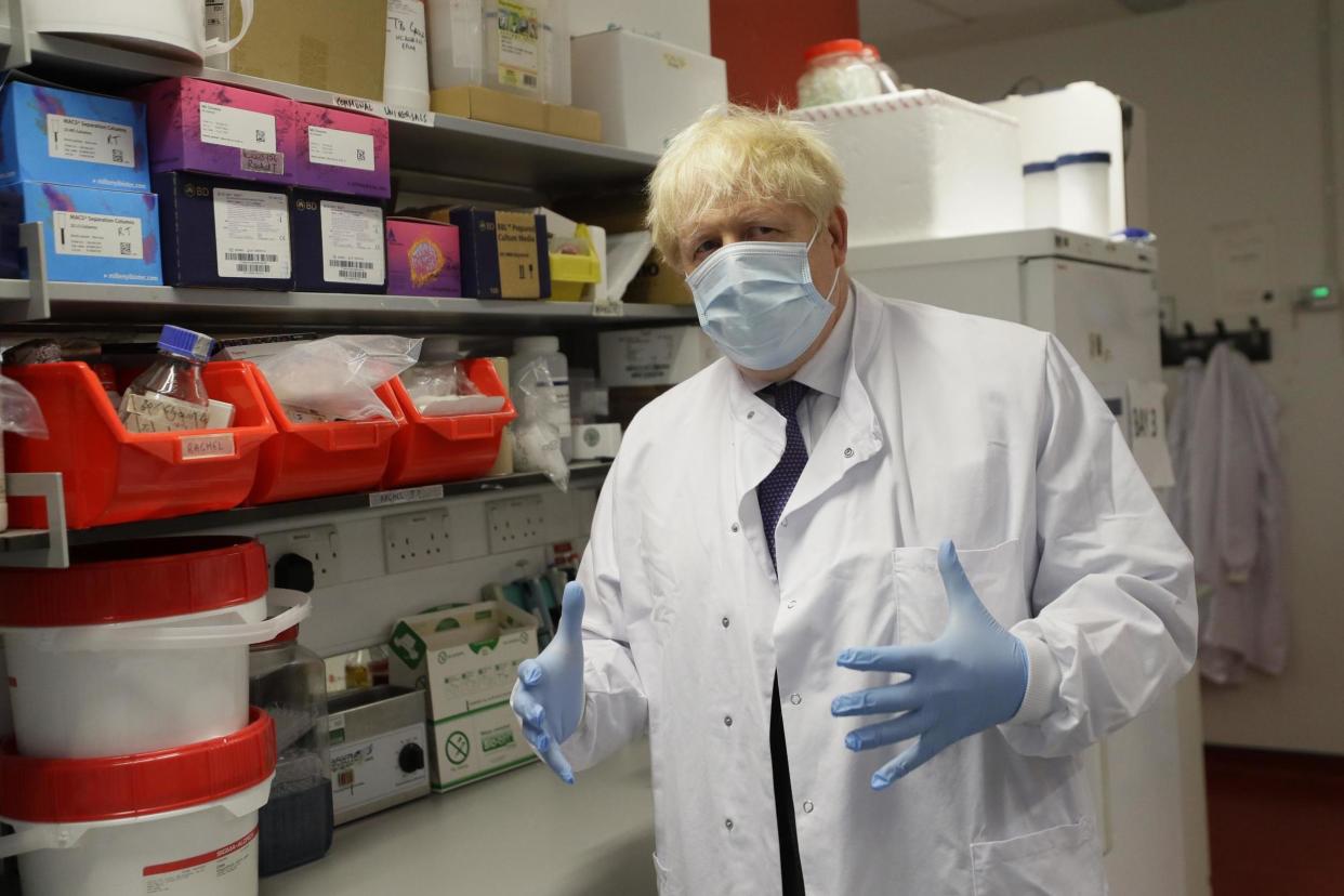 Boris Johnson gestures during a visit to the Jenner Institute in Oxford: PA