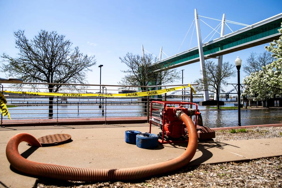 Water from the Mississippi River flows out of its banks over River Drive during a river flood warning, Wednesday, April 26, 2023, in Davenport, Iowa.