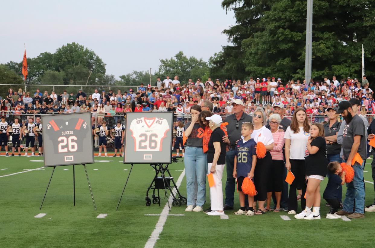 Family and friends gather on the 26-yard line as La Porte (Ind.) High School retires the No. 26 jersey of Jake West. West collapsed in September 2013 from an undetected heart condition. His mom, Julie, has spent the last decade trying to improve sideline safety for athletes in Indiana through AED donations.