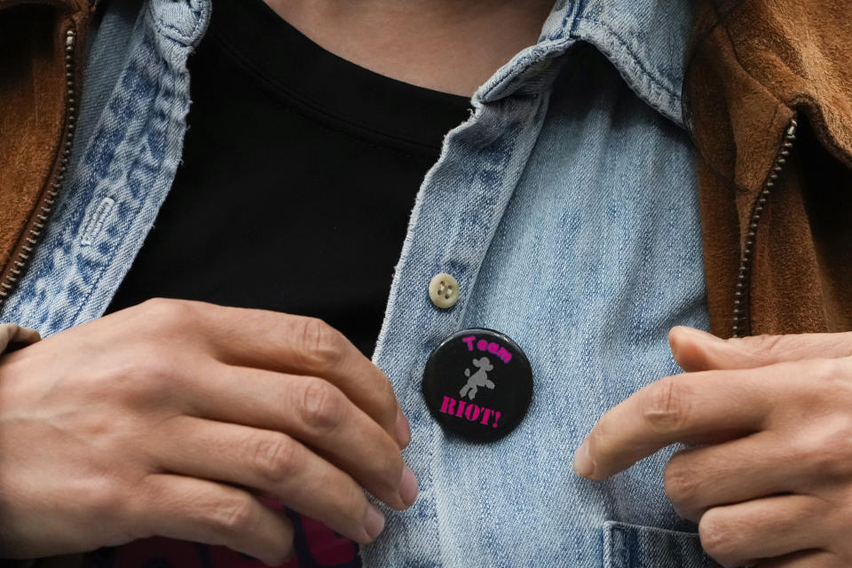 A woman puts on a dog pin during an agility competition during the 148th Westminster Kennel Club Dog show, Saturday, May 11, 2024, at the USTA Billie Jean King National Tennis Center in New York. (AP Photo/Julia Nikhinson)