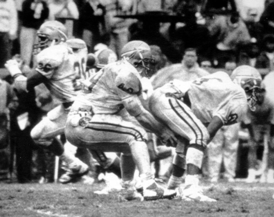 Florida State's Dayne Williams (left) shovels the ball between the legs of LeRoy Butler after taking the snap on a fake punt in the final minutes against Clemson, Sept. 17, 1988. Butler took off for a 78-yard gain to the Clemson 1.