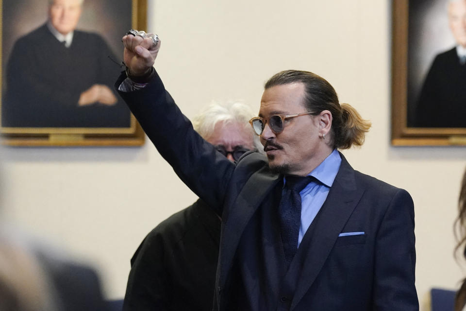 Actor Johnny Depp gestures to spectators in court after closing arguments at the Fairfax County Circuit Courthouse in Fairfax, Virginia, on May 27, 2022. - Actor Johnny Depp is suing ex-wife Amber Heard for libel after she wrote an op-ed piece in The Washington Post in 2018 referring to herself as a public figure representing domestic abuse. (Photo by Steve Helber / POOL / AFP) (Photo by STEVE HELBER/POOL/AFP via Getty Images)