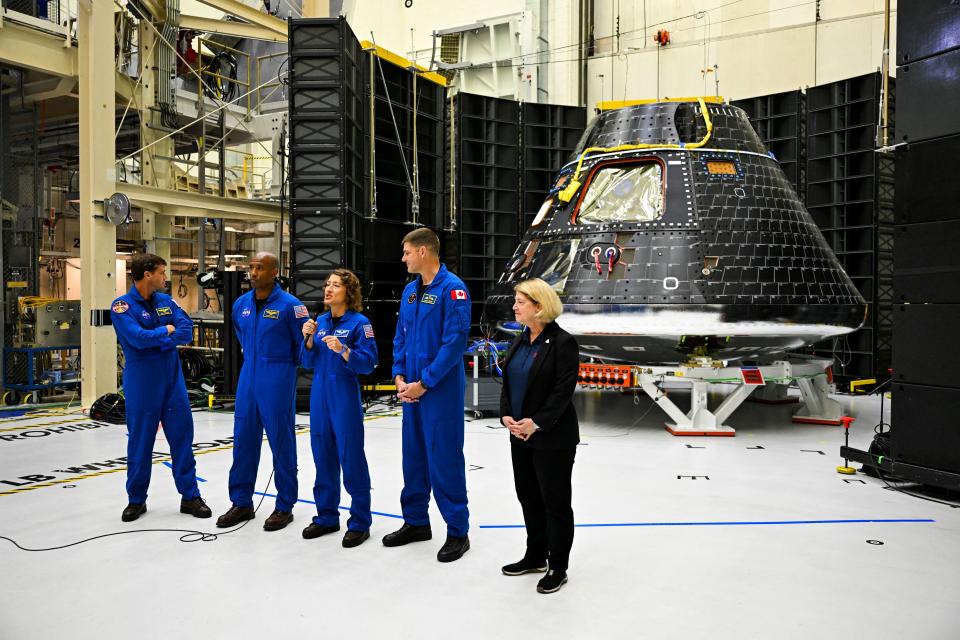 The crew of Artemis II stand with NASA Deputy Administrator, Pamela Melroythe in front of the Artemis II crew module on Tuesday. The crew will be part of the first lunar trip by astronauts in more than half a century.