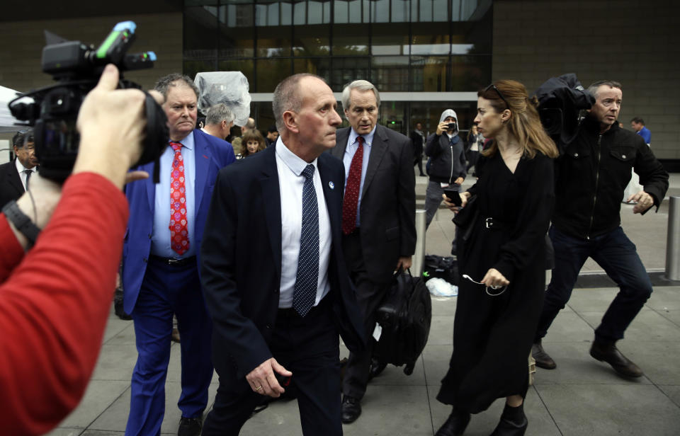 British cave explorer Vernon Unsworth, center, with his attorneys, Mark Stephens, second from left, and L. Lin Wood, right, walk out of Los Angeles U.S. District Court Friday, Dec. 6, 2019. A Los Angeles jury has found Elon Musk did not defame the British cave explorer when he called him "pedo guy" in an angry tweet. Unsworth, who participated in the rescue of 12 boys and their soccer coach trapped for weeks in a Thailand cave last year, had angered the Tesla CEO by belittling his effort to help with the rescue as a "PR stunt." (AP Photo/Damian Dovarganes)