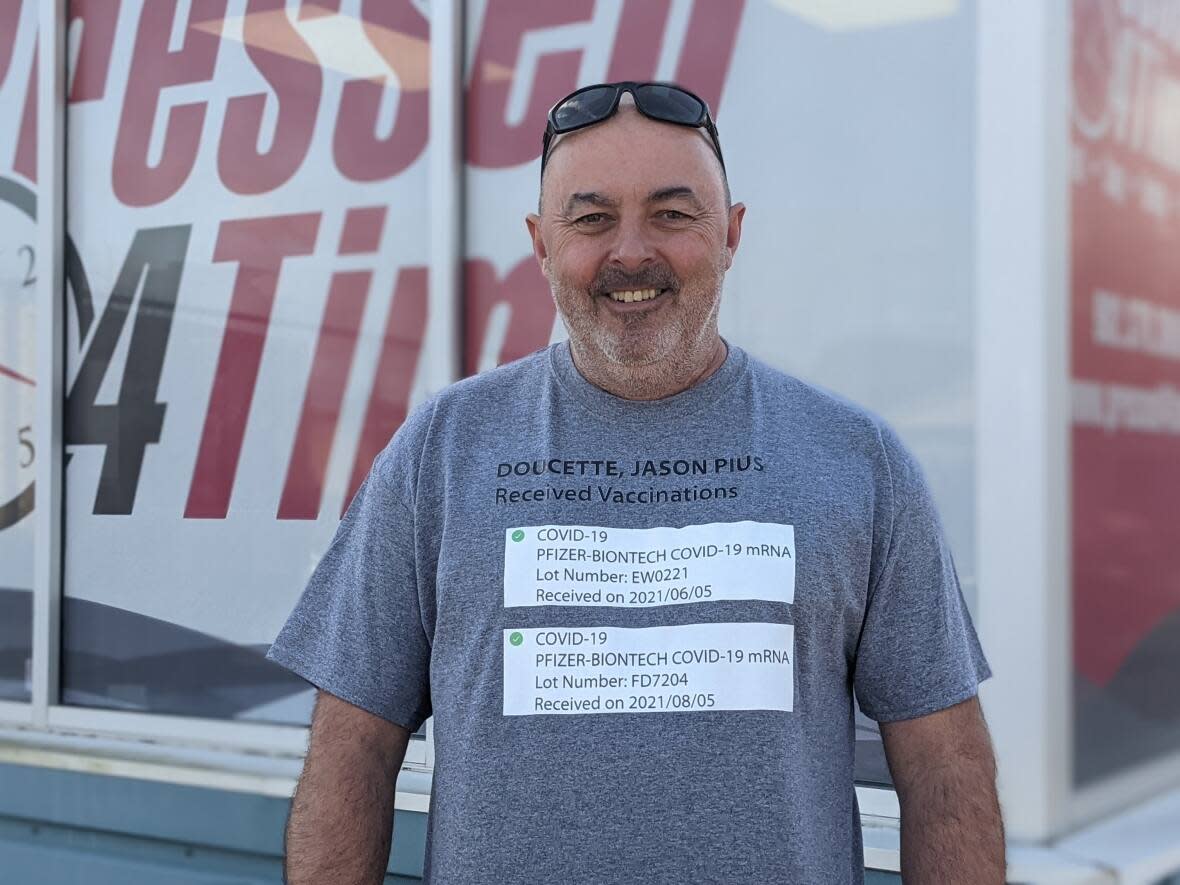 Jason Doucette says his Facebook blew up after he posted an image of himself wearing a shirt with his Vax Pass on it. (Shane Hennessey/CBC - image credit)