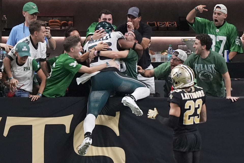 Philadelphia Eagles running back Saquon Barkley celebrates with fans after he ran 65 yards for a touchdown against the New Orleans Saints in the second half of an NFL football game in New Orleans, Sunday, Sept. 22, 2024. (AP Photo/Gerald Herbert)