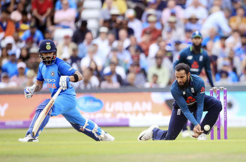 England’s Adil Rashid, right, and India’s Virat Kohli in action during the third One Day international cricket match between England and India at Emerald Headingley, Leeds, England, Tuesday, July 17, 2018. (Danny Lawson/PA via AP)