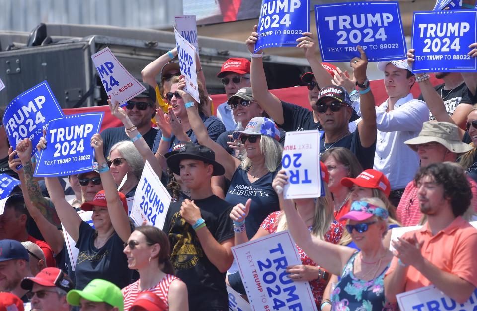 Guests react as former U.S. President Donald J. Trump takes the stage during the rally in downtown Pickens, S.C. Saturday, July 1, 2023. 