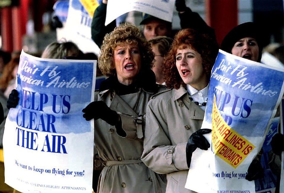 Striking American Airlines flight attendants chant slogans in November 1993 as they march on a picket line.<span class="copyright">Eugene Garcia/AFP/Getty Images</span>