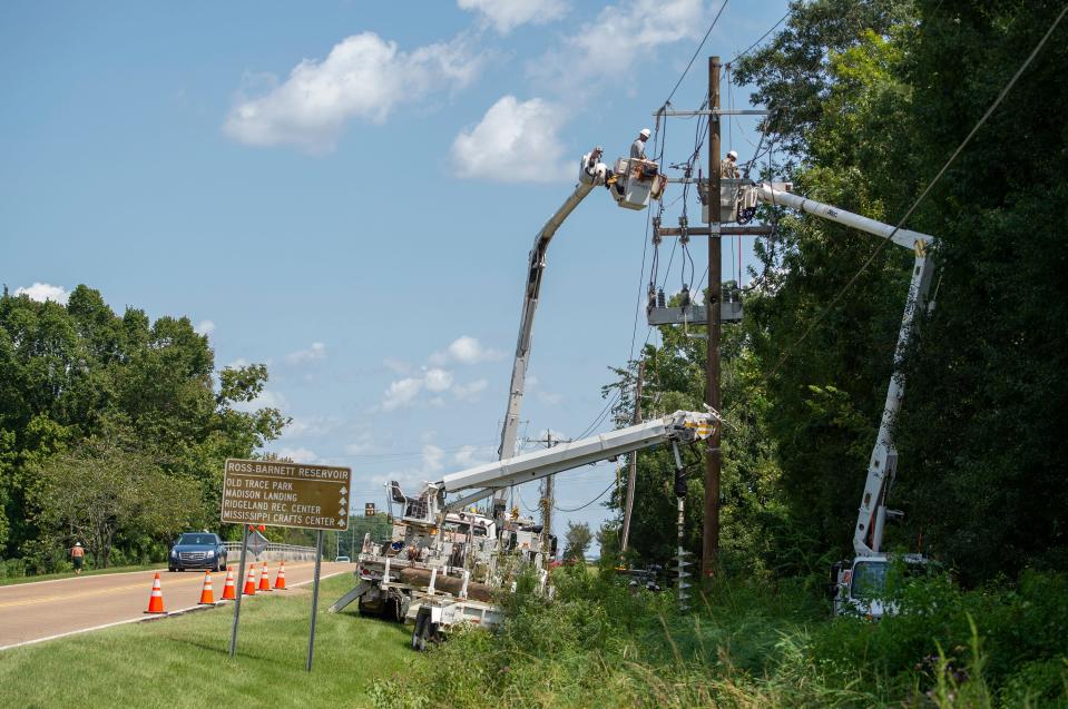 An Entergy crew works to replace a damaged pole after Hurricane Ida.