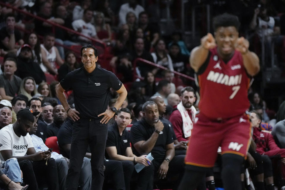 Miami Heat head coach Erik Spoelstra watches from courtside as Miami Heat guard Kyle Lowry (7) gestures to teammates during the first half of an NBA basketball game against the Memphis Grizzlies, Wednesday, March 15, 2023, in Miami. (AP Photo/Rebecca Blackwell)