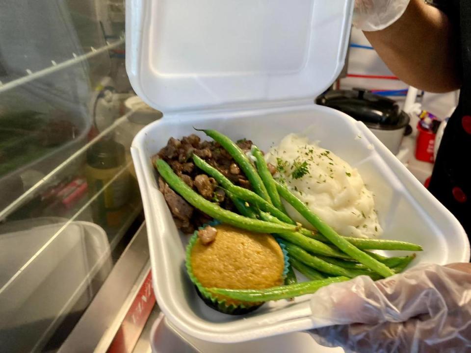 Ribeye steak strips served with mashed potatoes, sauteed green beans and brown sugar cornbread from the Signature Flavors Cafe & Catering food truck.