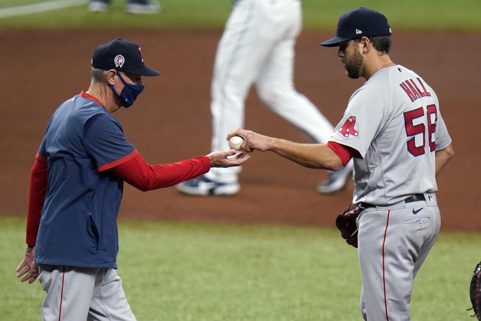 Boston Red Sox pitcher Matt Hall (56) hands the ball to interim manager Ron Roenicke as he is taken out of the game against the Tampa Bay Rays during the fourth inning of a baseball game Friday, Sept. 11, 2020, in St. Petersburg, Fla. (AP Photo/Chris O'Meara)