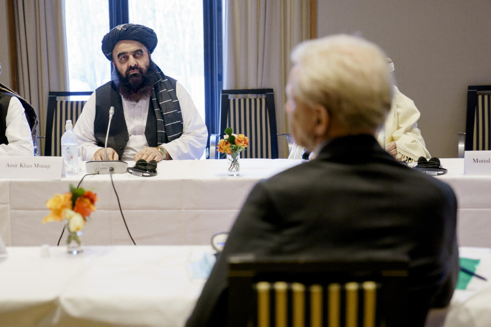 Taliban representatives Amir Khan Muttaqi , background, sits opposite Secretary General of the Norwegian Refugee Council Jan Egeland, during a meeting at the Soria Moria hotel in Oslo, Tuesday, Jan. 25, 2022. The last day of talks between the Taliban and western diplomats began in Oslo with a bilateral meeting with Norwegian government officials focused largely on the humanitarian situation in Afghanistan. The three-day talks opened on Sunday with talks between the Taliban and members of Afghan civil society, followed on Monday by multilateral talks with western diplomats, the EU, the U.S., Britain, France, Italy and hosts Norway. (Stian Lysberg Solum/NTB via AP)