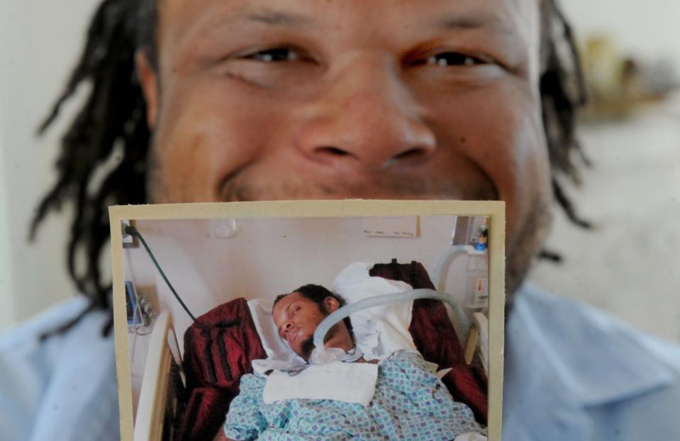 Langston Jackson, of Simi Valley, holds a photo taken when he was in a coma after an overdose in 2013. The former star athlete is now part of the class of 2020, after earning a degree from CSU Northridge.