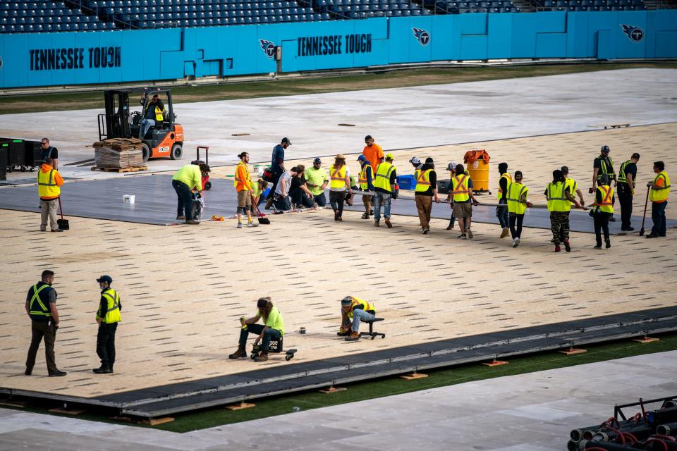 Workers continue building the hockey rink in preparation for the 2022 Navy Federal Credit Union NHL Stadium Series game at Nissan Stadium in Nashville, Tenn., Wednesday, Feb. 16, 2022.