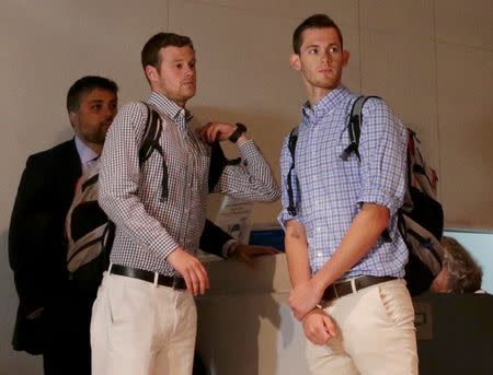 U.S. Olympic swimmers Jack Conger and Gunnar Bentz check in at the international airport to board a flight back to the U.S. after spending the day being interrogated by police in Rio de Janeiro, August 18, 2016. REUTERS/Ueslei Marcelino