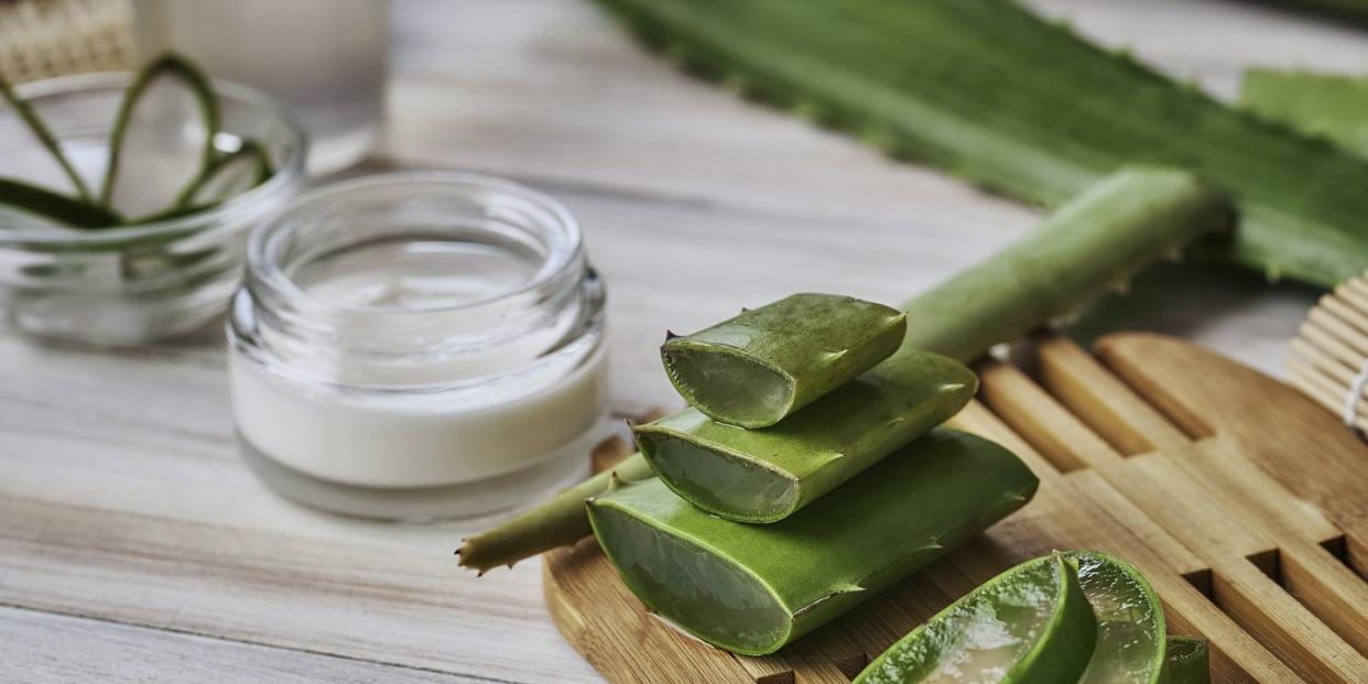 aloe vera slices and moisturizer on a wooden table beauty treatment concepts