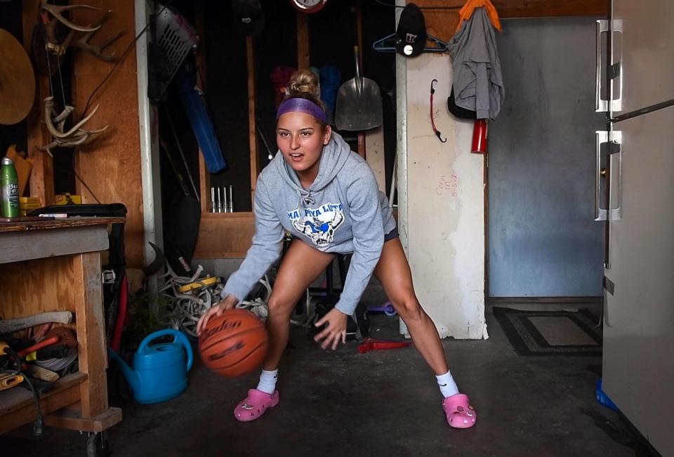 Stevi Fallis practices ball handling in her garage June 16 on the Pine Ridge Reservation.