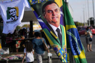FILE - A banner emblazoned with an image of Brazil's President Jair Bolsonaro, who is a candidate for reelection, is displayed for sale in Brasilia, Brazil, Aug. 2, 2022. Almost half a century later to the day, thousands are expected to rally on Aug. 11, for the readings of two documents inspired by the original “Letter to the Brazilians”. Both new manifestos defend the nation's democratic institutions and electronic voting system, which Bolsonaro has relentlessly attacked ahead of his reelection bid. (AP Photo/Eraldo Peres, File)