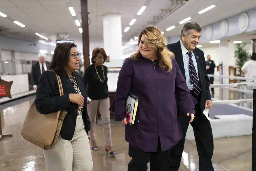 Rep. Norma Torres, D-Calif., left, speaks with Del. Jenniffer Gonzalez-Colon, R-Puerto Rico, joined at right by Rep. (AP Photo/J. Scott Applewhite)