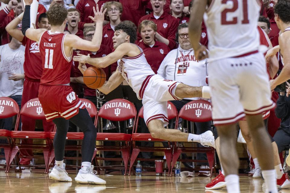 Indiana guard Anthony Leal, center, attempts to call a timeout as he falls to the court in the final seconds of an NCAA college basketball game against Wisconsin, Tuesday, Feb. 27, 2024, in Bloomington, Ind. (AP Photo/Doug McSchooler)