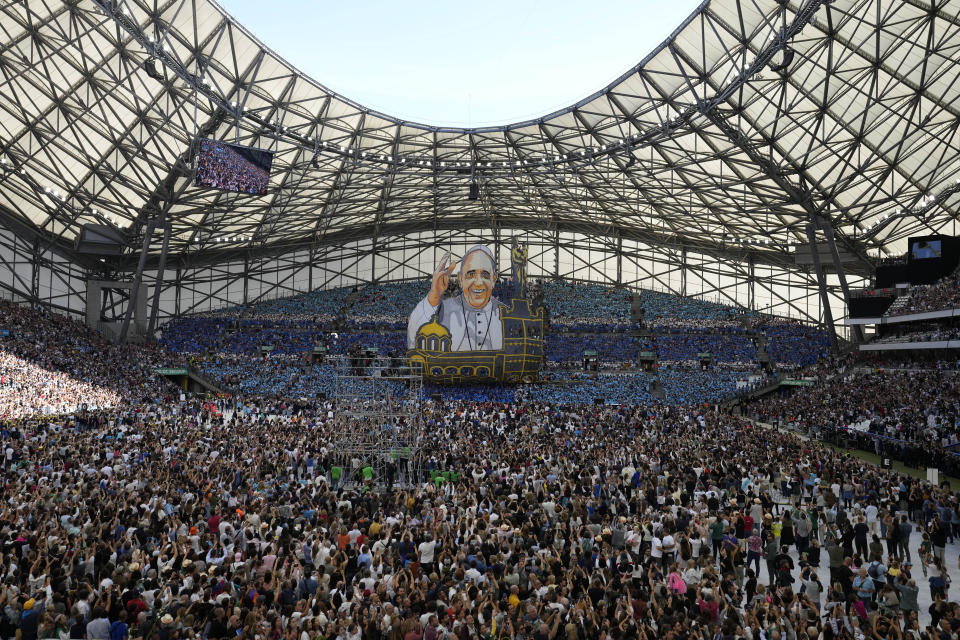 People wait for the arrival of Pope Francis at the "Velodrome Stadium", in Marseille, France, to celebrate mass, Saturday, Sept. 23, 2023. Francis, during a two-day visit, will join Catholic bishops from the Mediterranean region on discussions that will largely focus on migration. (AP Photo/Alessandra Tarantino)