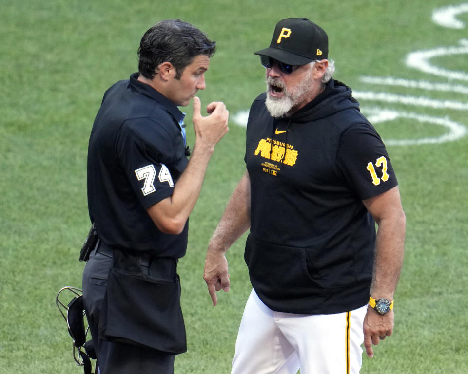 Pittsburgh Pirates manager Derek Shelton, right, questions a ball and strike call by umpire John Tumpane, left, during the seventh inning of a baseball game against the New York Mets in Pittsburgh, Saturday, July 6, 2024. Shelton was ejected for his protest. (AP Photo/Gene J. Puskar)