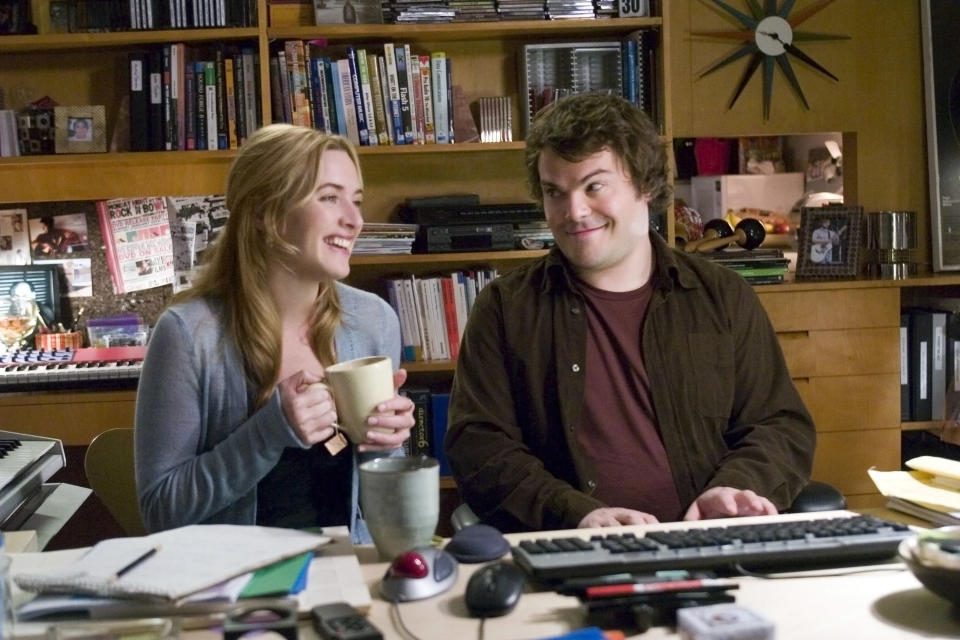 Kate Winslet and Jack Black sitting at a desk and laughing