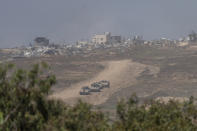 Israeli armored personnel carriers (APC's) move near the Israeli-Gaza border as seen from southern Israel, Wednesday, April 17, 2024. (AP Photo/Ohad Zwigenberg)