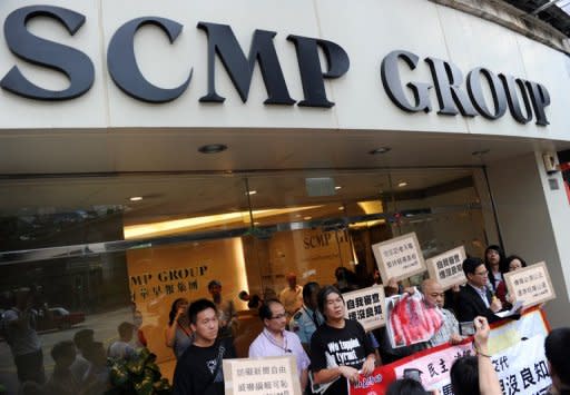 Members of the League of Social Democrats attend a protest outside the offices of the South China Morning Post (SCMP) newspaper in Hong Kong, on June 21. The protest was organised after the group claimed that the editor-in-chief of Hong Kong's largest English language paper censored a breaking story on the recent death of dissident Li Wangyang in China