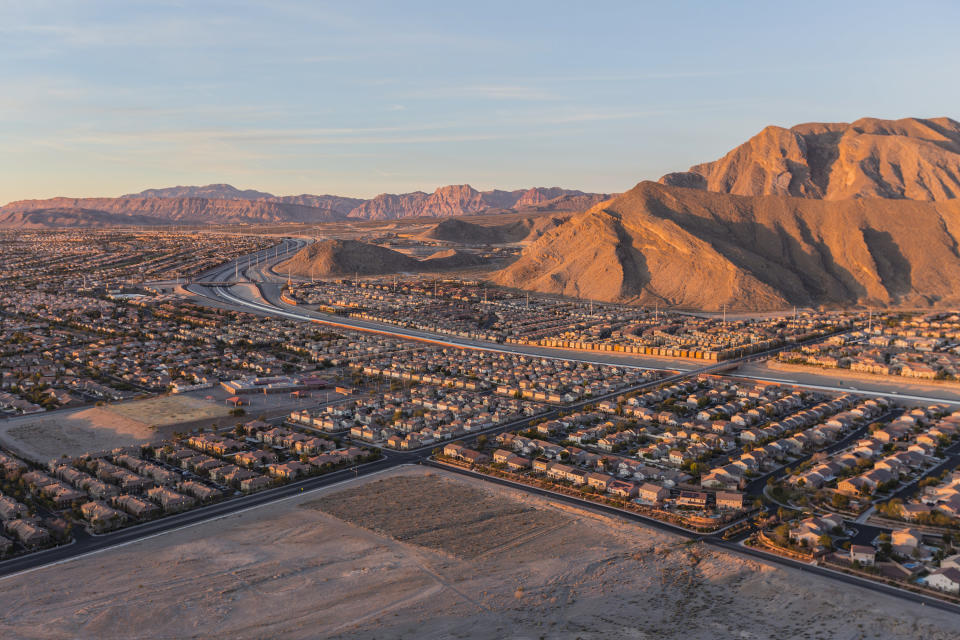 Overhead shot of a suburb of Las Vegas, surrounded by tall, sandy mountains