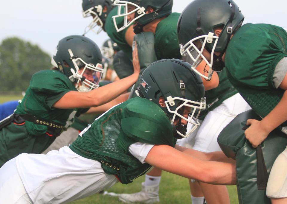 Jake Davis, front, and Gavin Wood participate in a defensive line drill during a Northridge football team camp on Wednesday, July 26, 2023.