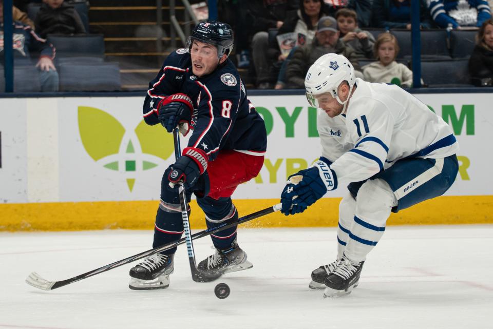 Dec 23, 2023; Columbus, Ohio, USA;
Columbus Blue Jackets defenseman Zach Werenski (8) attempts to score past Toronto Maple Leafs center Max Domi (11) during the third period of their game on Saturday, Dec. 23, 2023 at Nationwide Arena.