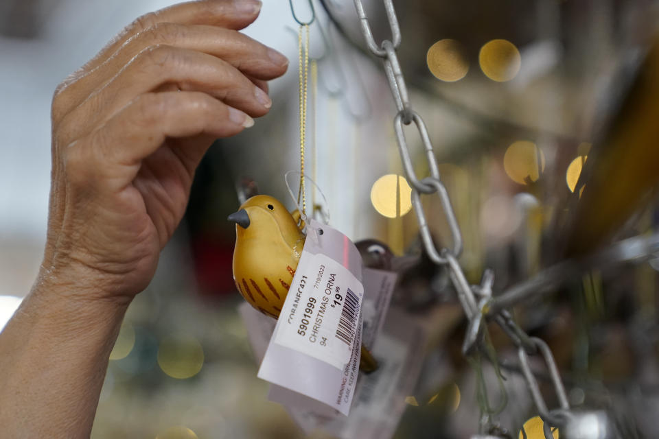 Blackhawk Hardware employee Palma Gonyea stocks holiday ornaments at the retail store, Wednesday, Nov. 1, 2023, in Charlotte, N.C. Holiday entertaining is back this year, and the store is seeing an influx of shoppers buying place settings, ornaments and indoor decorations. (AP Photo/Erik Verduzco)