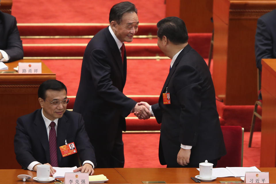 BEIJING, CHINA - MARCH 08:  Wu Bangguo (C), outgoing Chairman of the National People's Congress(NPC), shakes hands with Chinese Communist Party General Secretary Xi Jinping (R) near Chinese Vice Premier Li Keqiang (L) during a plenary session of the NPC held in Beijing's Great Hall of the People on March 8, 2013 in Beijing, China. Clearing urban air pollution has become a big concern during the National People's Congress.  (Photo by Feng Li/Getty Images)