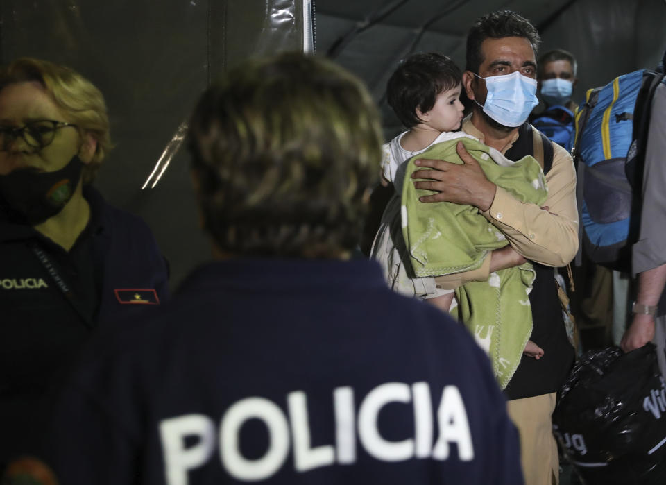 Evacuated citizens from Afghanistan arrive at Tirana International Airport in Tirana, Albania, Friday, Aug. 27, 2021. A government decision has planned that the Afghans may stay at least a year during which they will proceed with their application for special visas before they move on to the U.S. for final settlement. (AP Photo/Franc Zhurda)