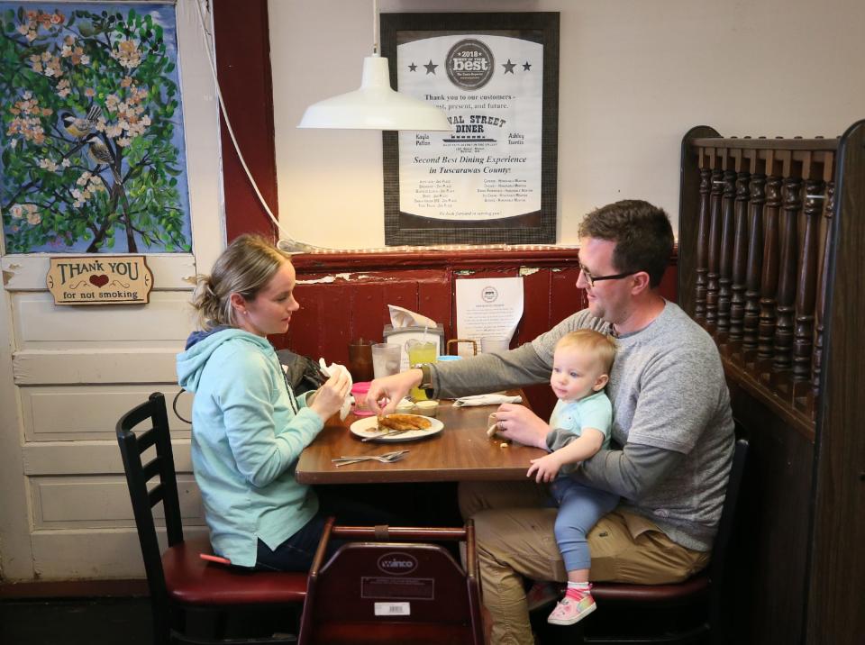 Chrissy and Tim McLaughlin and their daughter Joanna, 1, of Zoar, enjoy dinner at Canal Street Diner in Bolivar on Saturday.