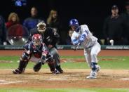 Oct 25, 2016; Cleveland, OH, USA; Chicago Cubs second baseman Javier Baez hits a single against the Cleveland Indians in the 7th inning in game one of the 2016 World Series at Progressive Field. Mandatory Credit: Charles LeClaire-USA TODAY Sports