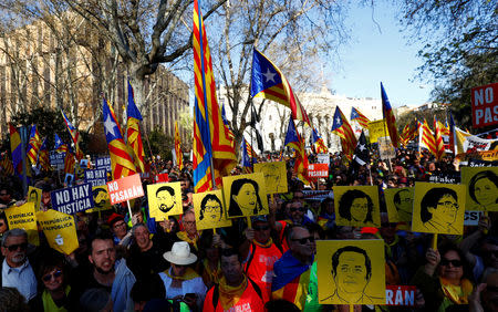 People hold banners depicting Catalan leaders' faces as they gather ahead of a rally of Catalan separatist organisations, in Madrid, Spain March 16, 2019. REUTERS/Juan Medina