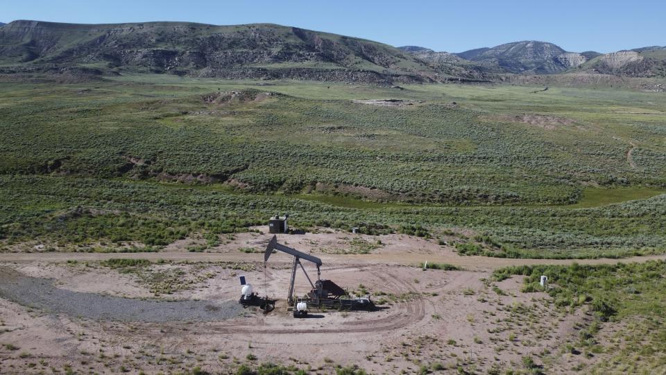 A pumpjack dips its head to extract oil in a basin north of Helper, Utah on Thursday, July 13, 2023. Uinta Basin Railway, one of the United States' biggest rail investments in more than a century, could be an 88-mile line in Utah that would run through tribal lands and national forest to move oil and gas to the national rail network. Critics question investing billions in oil and gas infrastructure as the country seeks to use less of the fossil fuels that worsen climate change. (AP Photo/Rick Bowmer)