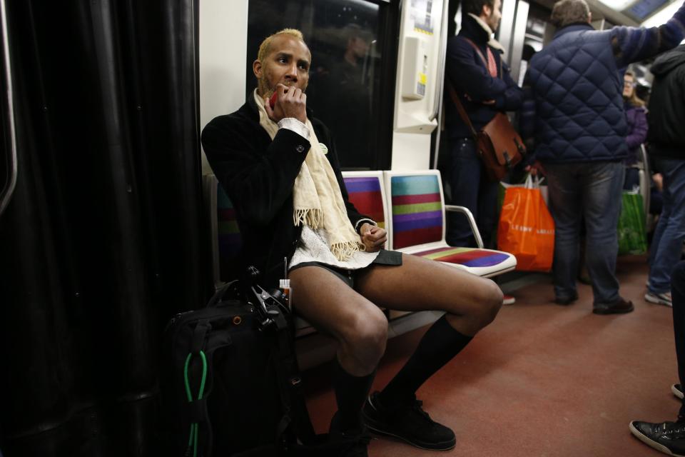 A passenger, not wearing pants, sits in a subway train during the "No Pants Subway Ride" in Paris
